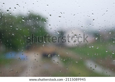 Rain drops on glass window background wallpaper 