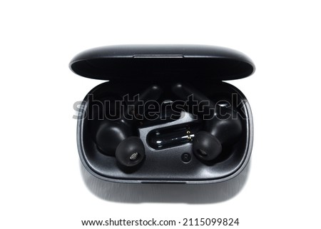 black wireless in-ear headphones in a case. isolation on white. front view