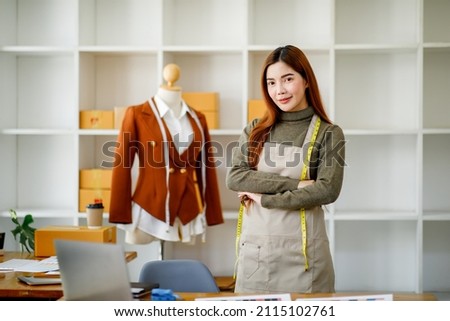 
Successful Fashion designer woman working on her designs in the studio, Asian business woman Fashion Designer Stylish Showroom Concept.
