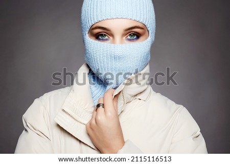 beautiful girl in blue balaclava. Trendy Mask on pretty woman. winter fashion Royalty-Free Stock Photo #2115116513