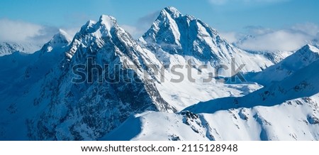 panoramic view over the swiss alps with snowy mountain summits. Royalty-Free Stock Photo #2115128948
