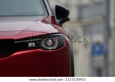 Detail on one of the LED headlights red Pickup Truck on black background,copy space Royalty-Free Stock Photo #2115130451
