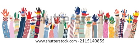 Arms raised up of multicultural children who have palms colored with the flags of various nations and countries. Group of multiethnic children and infants of different culture. Community Royalty-Free Stock Photo #2115140855