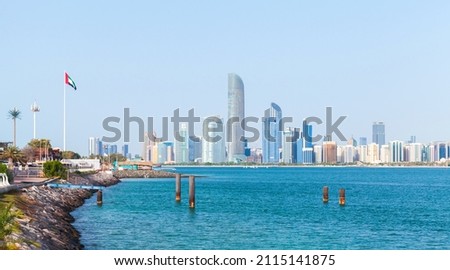 Abu Dhabi, cityscape with tall skyscrapers towers under clear blue sky on a sunny day