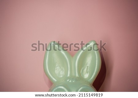 Bunny ears on a pink background with space for text.