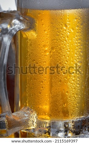 Light beer in a glass, on an old background.