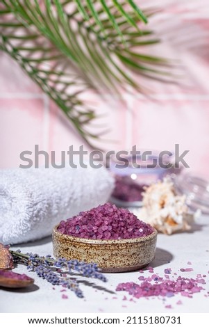 Purple bath salt with lavender, towel and candles vertical photo