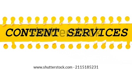 Torn paper strip on yellow background with text CONTENT SERVICES