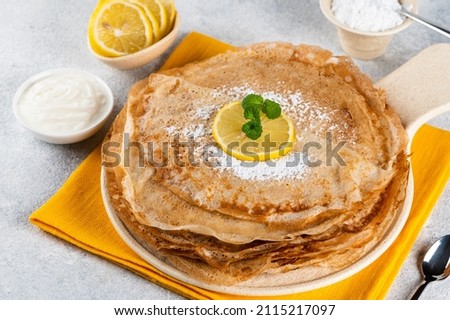 Pancakes with lemon and sugar. Traditional for Shrove Tuesday. Pancake day. Pancakes with lemon juice and powdered sugar. Russian Maslenitsa. Sweet crepes. shrovetide holiday Royalty-Free Stock Photo #2115217097