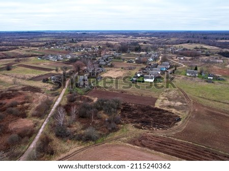 Wooden home in village. Country houses in countryside.  Suburban house at countryside spring season. Rural housing in autumn. Russian region. Drone viev of the roofs of rural homes in countryside.