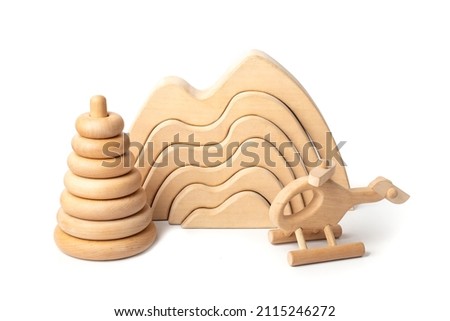 Cute wooden baby toys. Children's wooden toys on a white background The concept of learning and education. Eco accessories, beanbag and teethers for newborn. Flat lay, top view