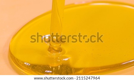 MACRO, DOF: Detailed shot of unrefined cold pressed walnut oil getting poured into a container. Delicious organic extra virgin olive oil flows into a deep dish. Natural hair and skin care product. Royalty-Free Stock Photo #2115247964