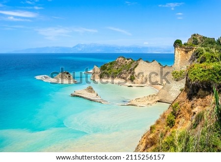 Cape Drastis cliffs near Sidari and Peroulades on Corfu island in Greece. Famous rock formations with small beach and rugged coastline. Popular Greek destination for summer vacation Royalty-Free Stock Photo #2115256157
