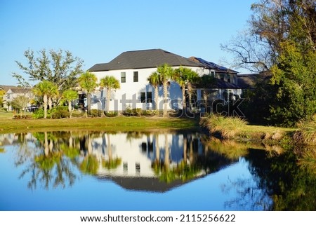  house and pond in a sunny day