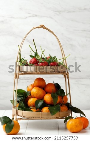 Strawberry and Mandarin Orange on Bamboo Tier, Fresh Fruit for Chinese New Year Concept