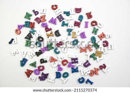 Group of colorful wooden letters on white background.
