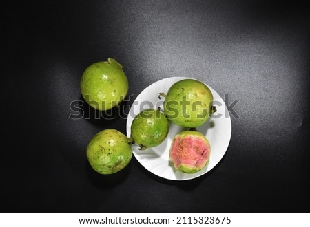 sweet pink guava with one already bitten. fruit photo background
