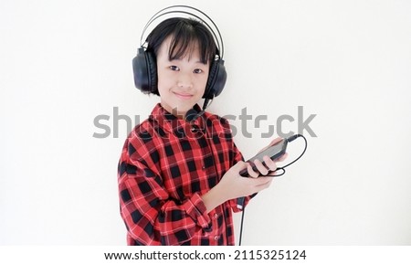 girl listening to music with headphones on winter holiday.