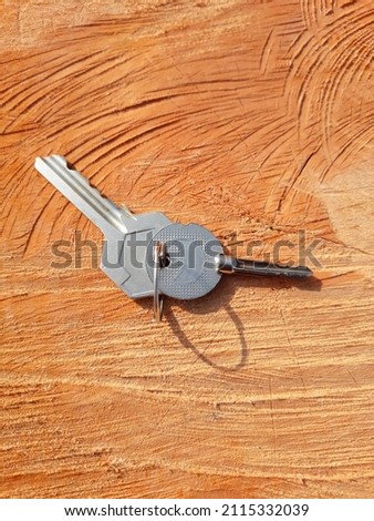 Two keys that one is hause key and another is  bicycle key with isolated on wood background.