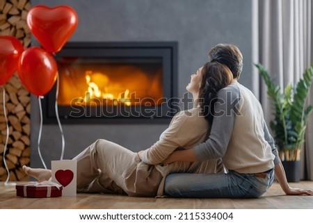 Happy loving couple on valentine's day. Man and woman are enjoying spending time at home. Royalty-Free Stock Photo #2115334004