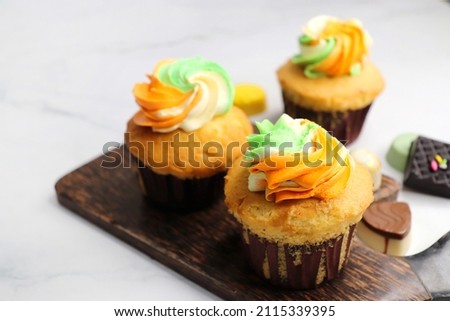 Tiranga Cupcake or Tricolor Cupcake with Indian National Flag colors frosting. saffron or orange, white and green. The concept for Indian happy Independence or Republic day greeting card. copy space.
