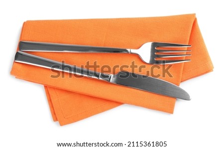 Orange napkin with fork and knife on white background, top view Royalty-Free Stock Photo #2115361805