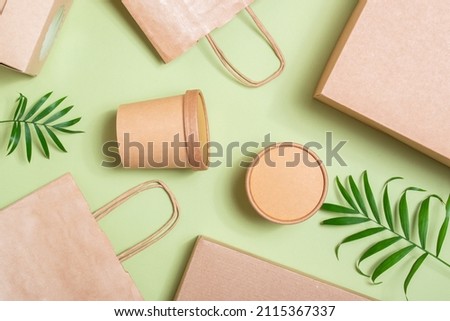 Paper packaging on a soft green background. Food delivery, takeaway. Environmental protection. Zero waste.