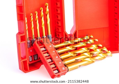 Set of drill bits for drill in red box isolated on white background.
