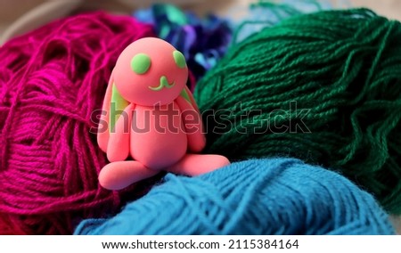 plasticine craft in the shape of an easter pink rabbit close-up selective soft focus