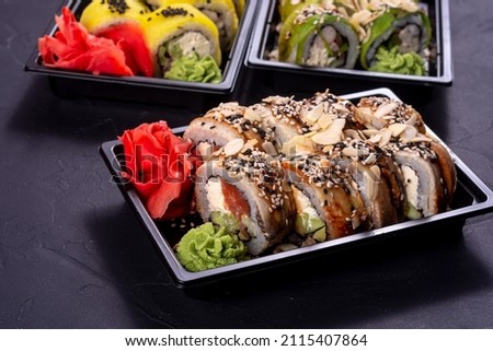 Traditional Japanese rolls with eel and almond flakes in box. Delivery sushi menu