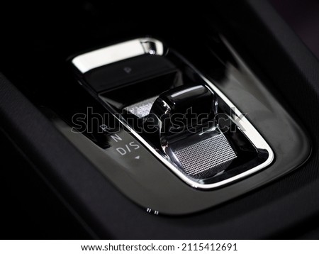 modern automatic gearbox gear selector. stylish car interior dark with chrome