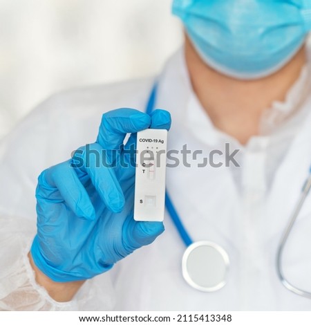 Close up of hand in protective glove holds rapid antigen test for covid-19 in laboratory. Quick swab method to test Coronavirus SARS-CoV-2. PCR Royalty-Free Stock Photo #2115413348