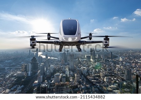 Autonomous driverless aerial vehicle flying on city background, Future transportation with 5G technology concept Royalty-Free Stock Photo #2115434882