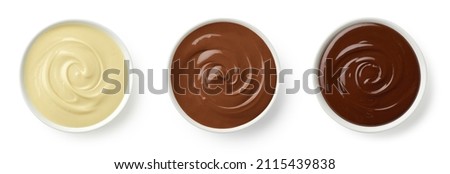 Set of various melted chocolate bowls (dark, milk and white) isolated on white background, top view Royalty-Free Stock Photo #2115439838