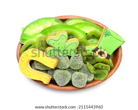 Plate with different sweets for St. Patrick's Day celebration on white background