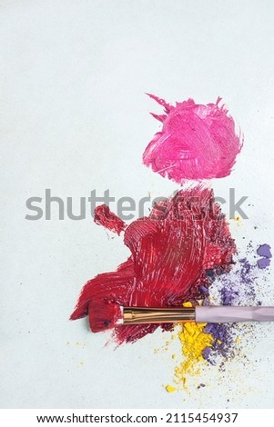 A photo of Makeup Brush On Eyeshadow And Lip Colors Photo