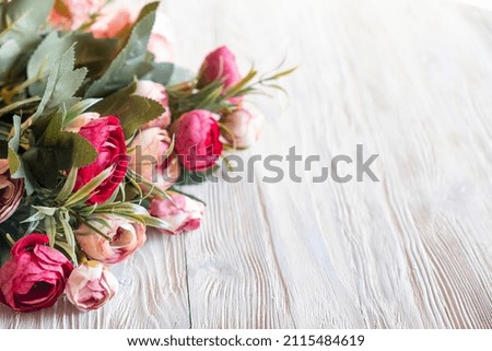 Pink peonies flowers on wooden board with copy space