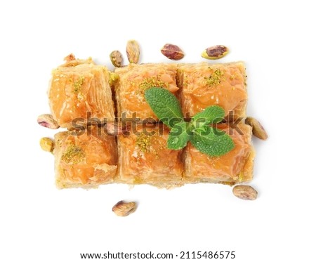 Delicious baklava with pistachios, mint and scattered nuts on white background, top view