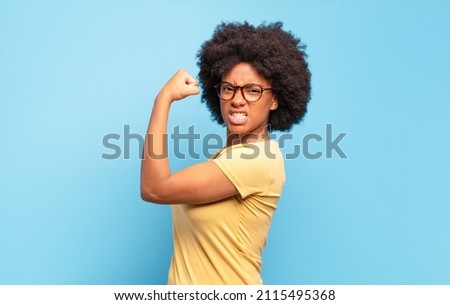 feeling happy, satisfied and powerful, flexing fit and muscular biceps, looking strong after the gym Royalty-Free Stock Photo #2115495368