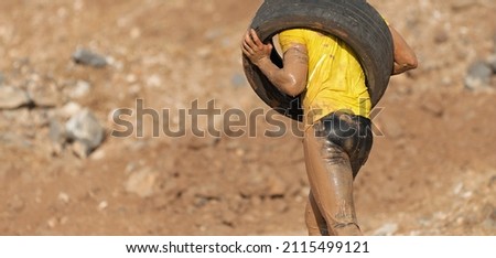 Runner carrying tire in a test of the race
