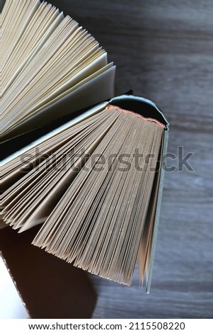 Bunch of vintage hardcover books on wooden background. Top view.