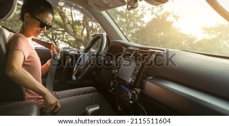 Female driver buckle up the seat belt before driving car Royalty-Free Stock Photo #2115511604