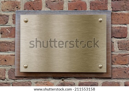Brass or bronze metal plate on brick wall
