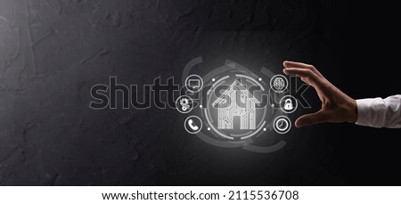Hand hold house icon.Smart home controlled, intelligent house, and home automation app concept.Pcb design and person with smart phone. Innovation technology internet Network Concept Royalty-Free Stock Photo #2115536708