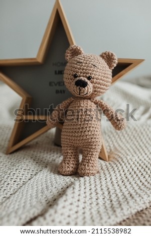 Knitted beige teddy bear on a light background
