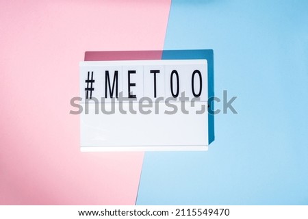 Me too hashtag on the lightbox. Concept of feminism on a blue and pink background. Top view