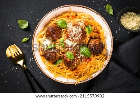 Pasta with Meatballs in tomato sauce at black.