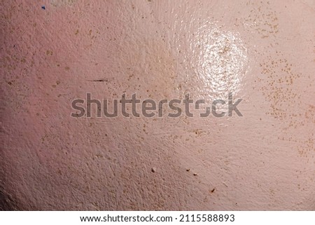 The cement is painted pink with a reflective surface. The weight of light has both bright and bright angles. and dark corners look gloomy It's dirty and old. Use it as a texture or background.