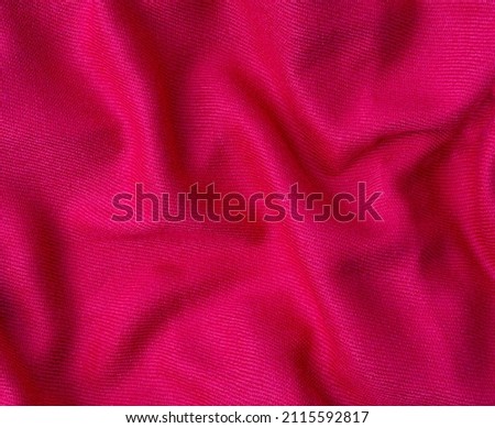 wrinkled pink fabric texture background close up