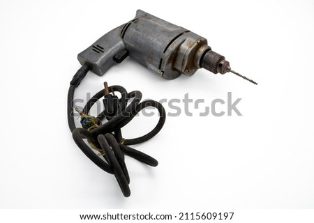 Vintage Electric Drill Showcased With A White Background. A solid metal vintage corded electric drill with drill bit ready for use. Royalty-Free Stock Photo #2115609197